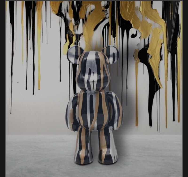 standing bear with paint drips in silver and gold 